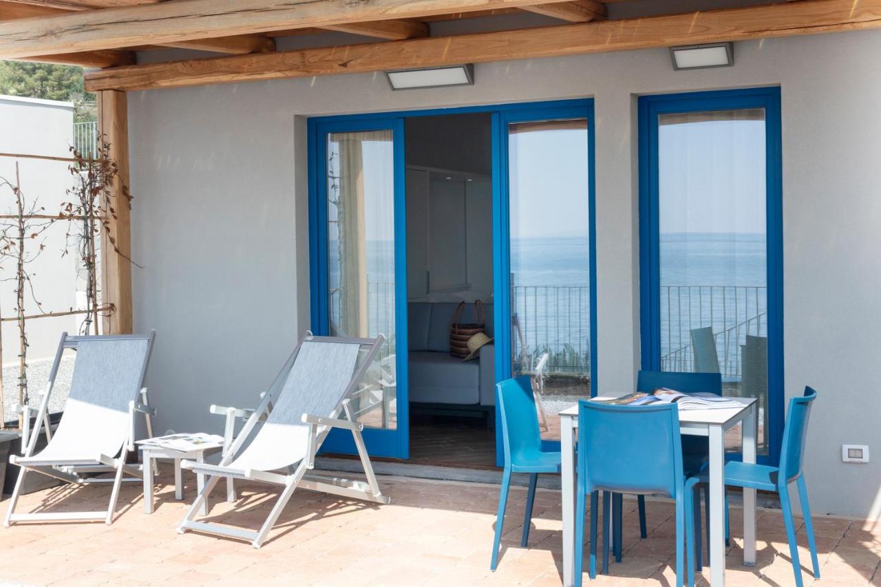 Patio privato con lettini e tavolo davanti al villino